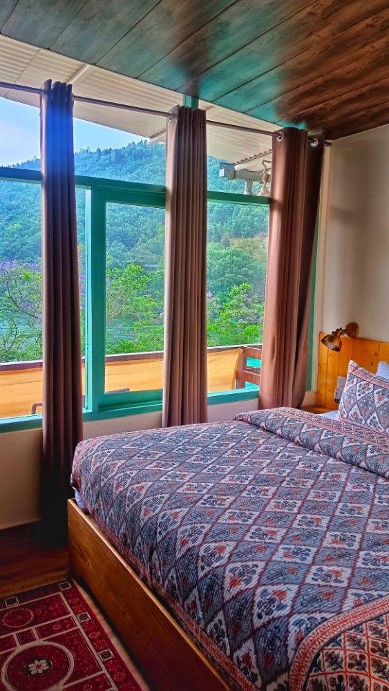 Cozy bed with warm lighting and balcony view